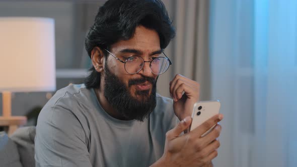 Close Up Bearded Arabian Indian Millennial Man Looking in Smartphone Says Wow Unexpected News Online