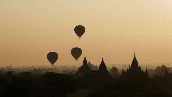 Balloons flying during sunrise over the Pagodas