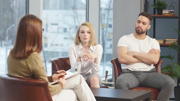 Young Caucasian Couple Offended By Each Other Sit at Consultation with Family Psychologist