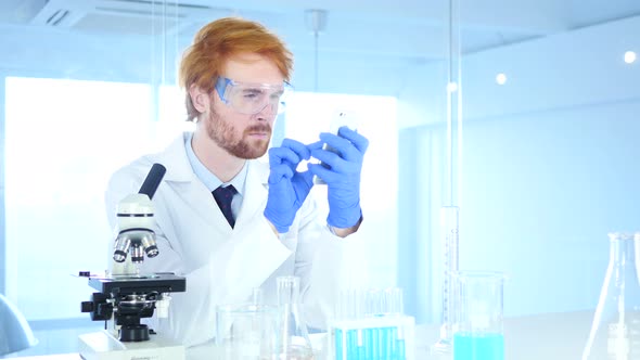 Scientist Using Phone in Laboratory