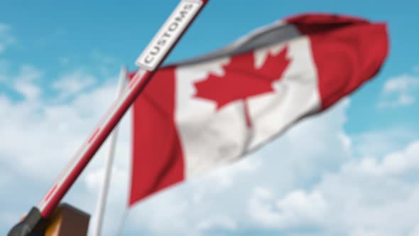 Closing Barrier with CUSTOMS Sign Against the Canadian Flag alt