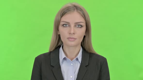 Young Businesswoman Looking at Camera Against Chroma Key