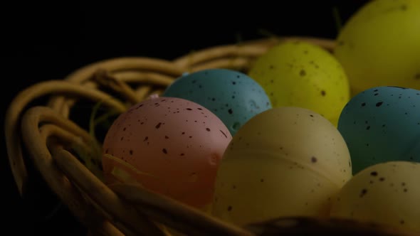 Rotating shot of Easter decorations and candy in colorful Easter grass