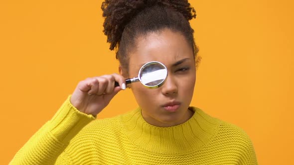 Serious African Woman Looking Through Magnifying Glass, Female Detective, Search
