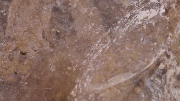 Flint stone surface texture macro shot, very close up view with rotating motion studio shot.