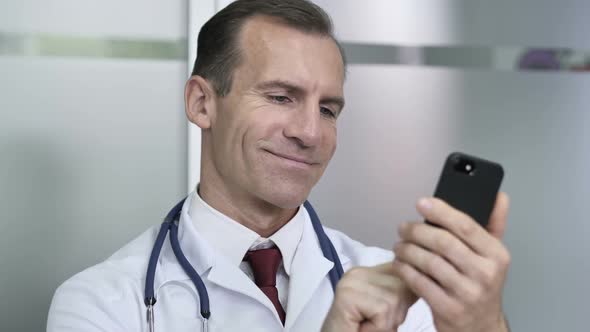 Doctor Browsing Internet on Smart Phone