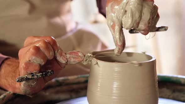 Mid section of potter making pot