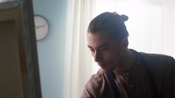 Young Man In Counter Light Is Painting