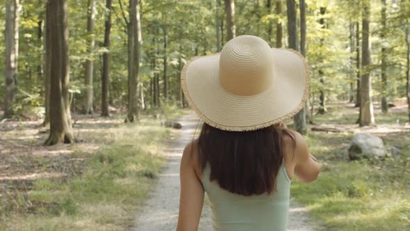 Teenage Girl In Sun Hat In Forest