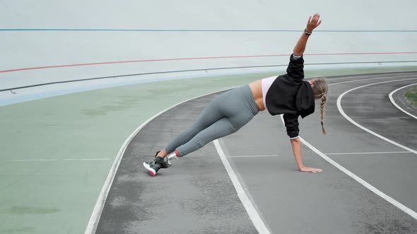 Disabled Athlete Standing in Plank on Hand at Track. Girl Practicing Yoga