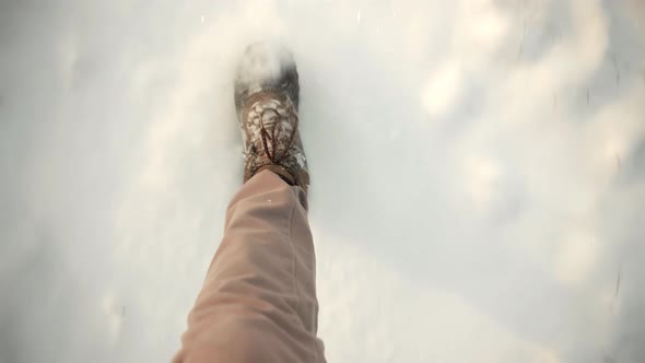 Man Legs Walking In Snow. Male In Snowy Weather At Cold Temperature Walking Alone. Legs Footprints.