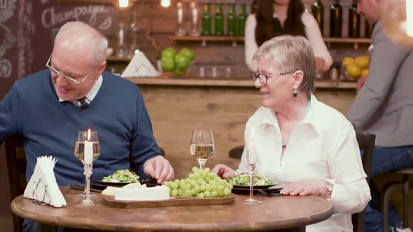 Old Man Offers Flowers To His Date on a Romantic Dinner