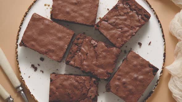 Delicious Homemade Chocolate Brownies Served on White Plate Over Beige Background