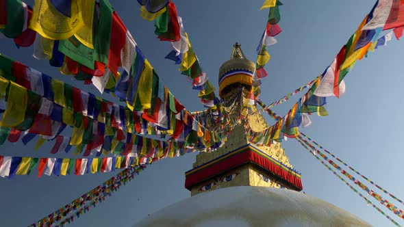 Prayer Flags at Boudhanath Stupa in Sunrise Lights. Kathmandu, Nepal . Crane Shot, FHD, 