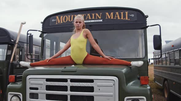 Dancer In Yellow Doing Splits On Bus