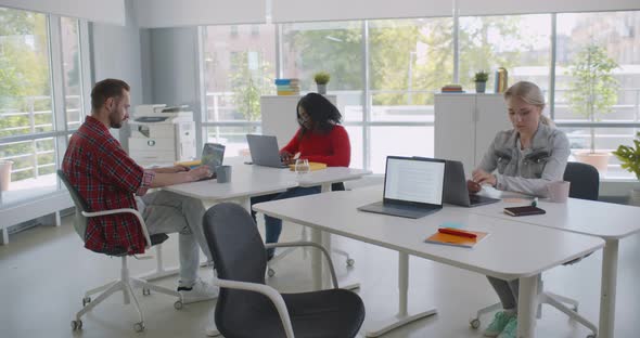 Group of Diverse Students or Employees Using Laptop Studying and Working at Open Space Office