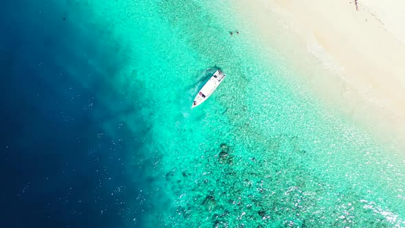 Beautiful birds eye island view of a sandy white paradise beach and blue water background in colourful