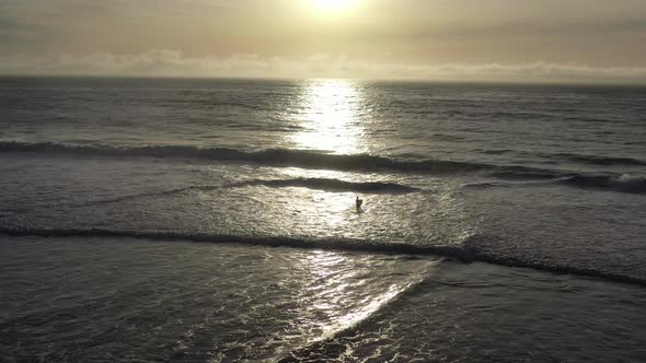 Aerial of Surfer and Sunset