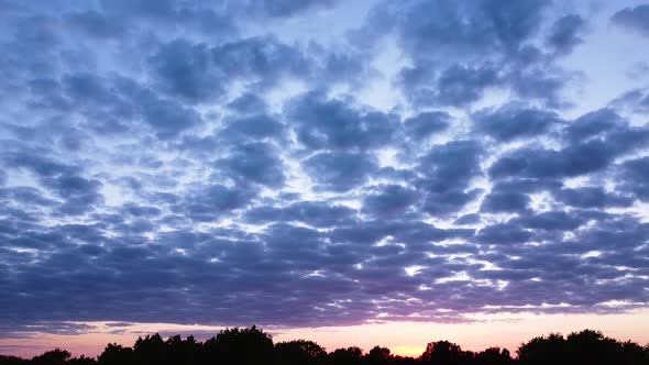 Beautiful aerial vibrant high contrast pink purple sunset with blue clouds over Baltic sea at Liepaj