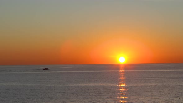 Maine lobster fishing boat heading out to sea at sunrise