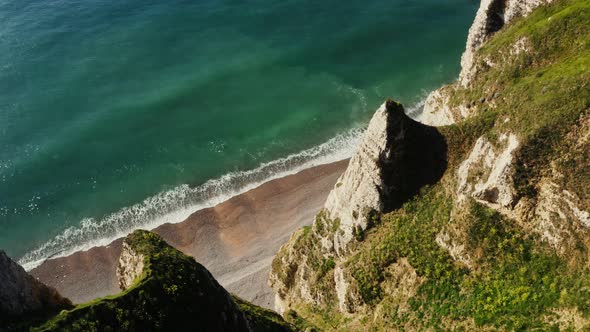 View From Above From the Top of a Cliff with Sharp Peaks to the Seashore