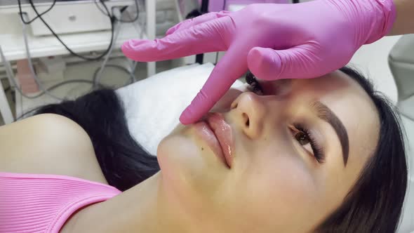 Lip augmentation procedure by a cosmetologist in the spa center