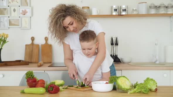 Mother and Son Cut Vegetables Together