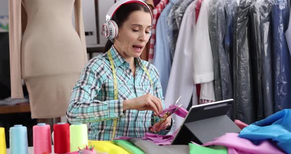 Smiling Seamstress Designer Cuts Fabric in Atelier