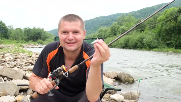 A Male Fisherman Blogs and Tells the Camera About Fishing Lures