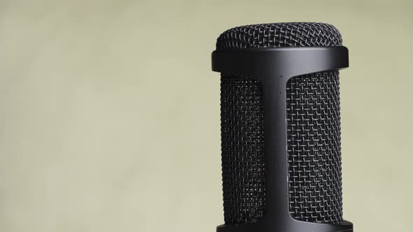 Studio Condenser Microphone Rotates on Yellow Background with Place for Text