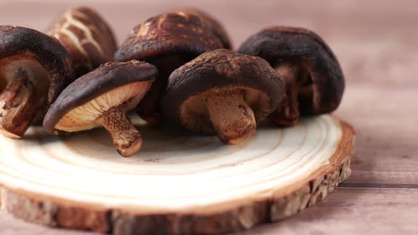 Raw Champignon Mushroom on a Chopping Board on Table