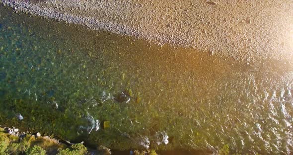 Low Altitude Flight Over Fresh Fast Mountain River with Rocks at Sunny Summer Morning.