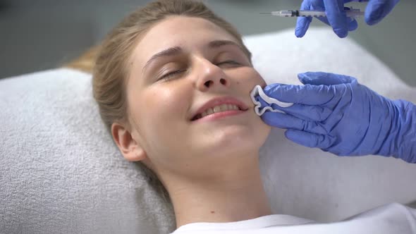 Girl Making Beauty Injections to Smooth Wrinkles and Make Better Face Shape