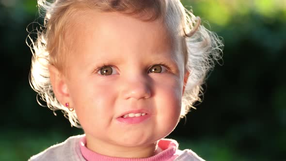 Beautiful Face of a Small European Child the Sun Illuminates Her Hair