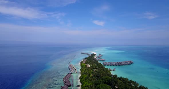 Natural drone copy space shot of a sunshine white sandy paradise beach and aqua blue water backgroun