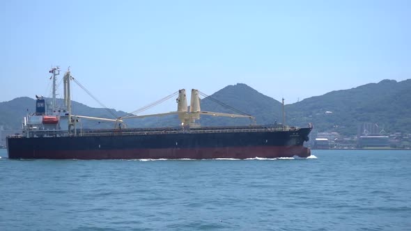 Merchant Ship Sails along the Coast