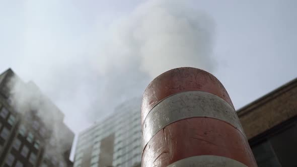 Steam Comes From a Striped Orangewhite Pipe