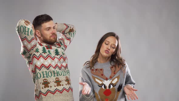 Happy Couple in Christmas Ugly Sweaters Dancing 21