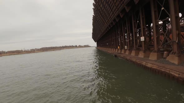 FPC drone flying past industrial dock for loading mining resources into freight ships on Lake Superi