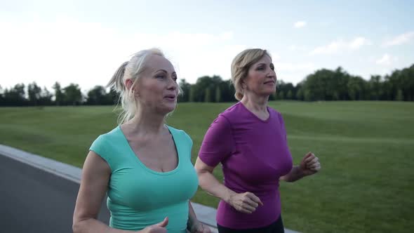 Active Fit Senior Female Athletes Running Outdoors