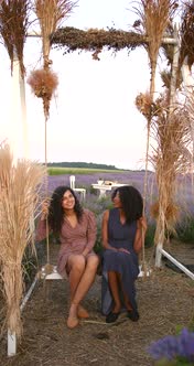 Female Diverse Friends on a Swing in Lavender Field