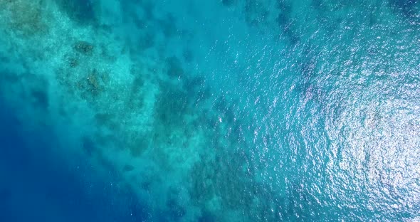 Beautiful overhead travel shot of a white sandy paradise beach and aqua blue ocean background