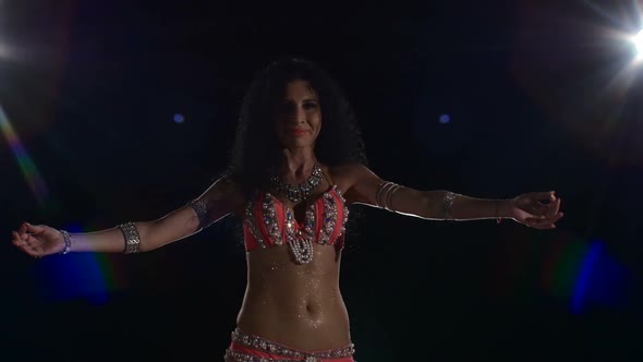Torso of a Beautiful Young Girl Belly Dancer on a Black, Back Light, Cam Moves Up