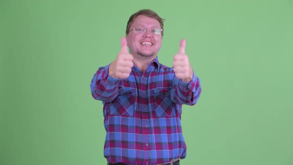 Happy Overweight Bearded Hipster Man Giving Thumbs Up and Looking Excited