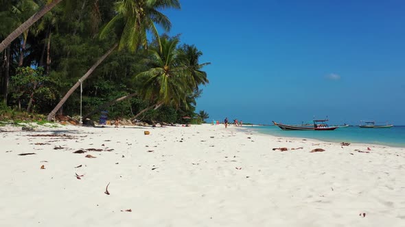 Aerial flying over scenery of marine island beach lifestyle by aqua blue lagoon with white sandy bac