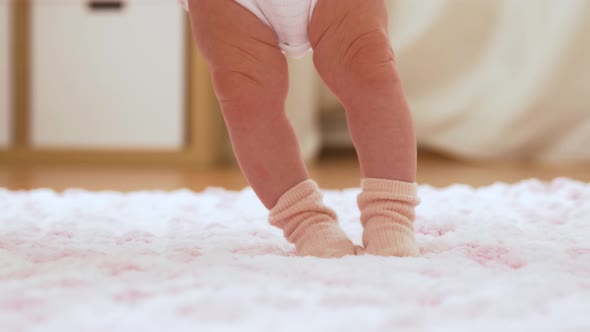 Baby's Feet Stepping on Knitted Plush Blanket