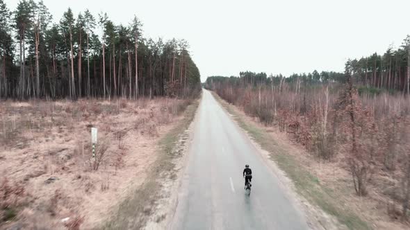 Cyclist riding a bike on empty car road