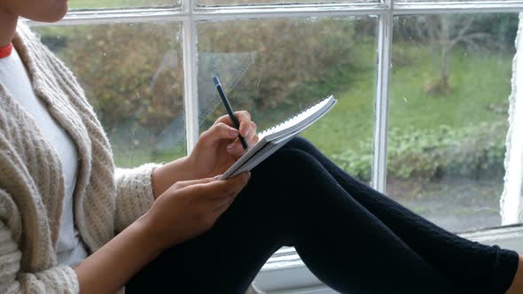 Woman sketching on notepad