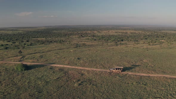 4 wheel drive vehicle on wildlife safari in Kenya. Aerial drone view of safari vacation