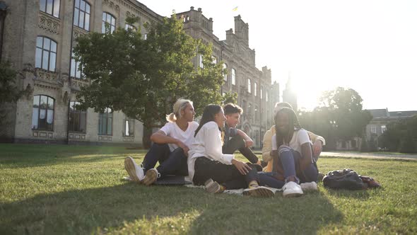 Multiracial Friends Spending Time on Campus Lawn